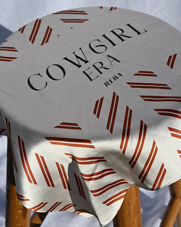 Stool with 'Cowgirl Era' cover on a white background