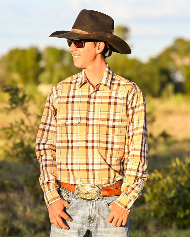 Person wearing a cowboy hat and plaid shirt in a natural setting