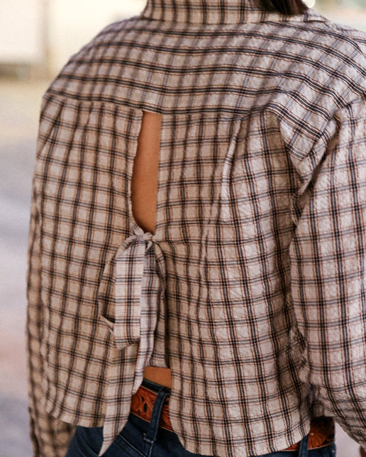 Plaid shirt with cut-out design and tied front, worn by a person.